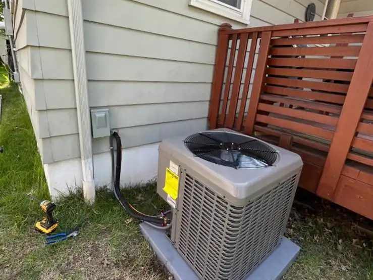 A new central air conditioner condenser we installed beside a deck