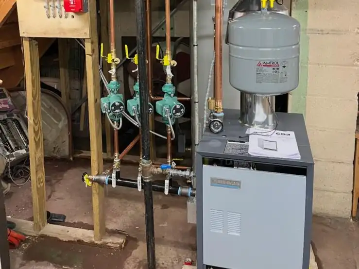 A new gas boiler with three-zone circulator pumps we installed in a New Jersey basement