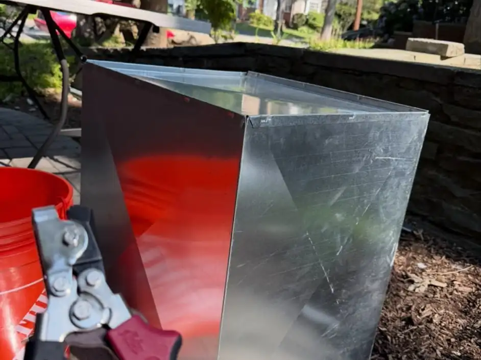 A hand-formed sheet-metal duct fitting made on site by our crew