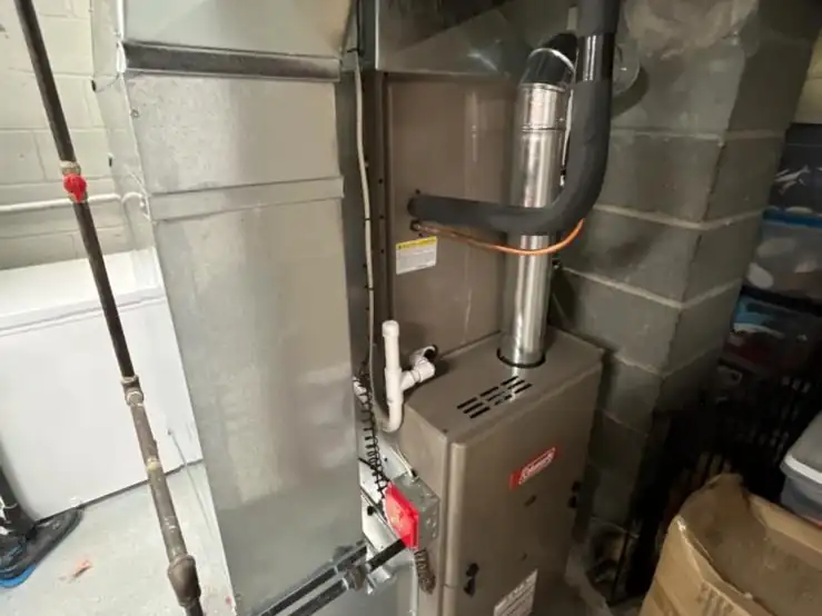 A new gas furnace and return plenum we installed in a garage utility area