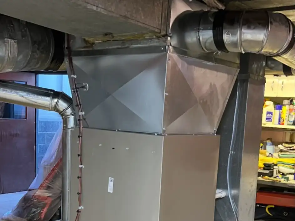 A new gas furnace with a custom sheet-metal plenum and ductwork we installed