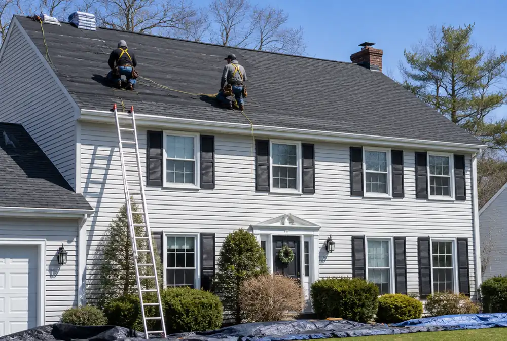 Crew installing new architectural shingles on a New Jersey colonial